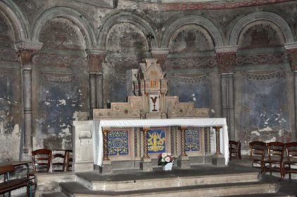 L'autel de l'abside nord devant une arcature romane.