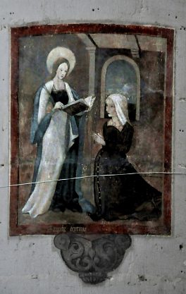 Sainte Aprône s'apprête à guérir une paysanne agenouillée devant elle (fresque sur une pile)