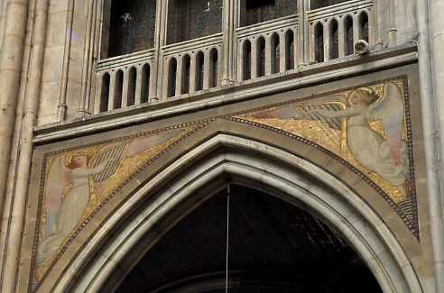 Peinture murale d'anges musiciens dans les écoinçons des arcades de la nef